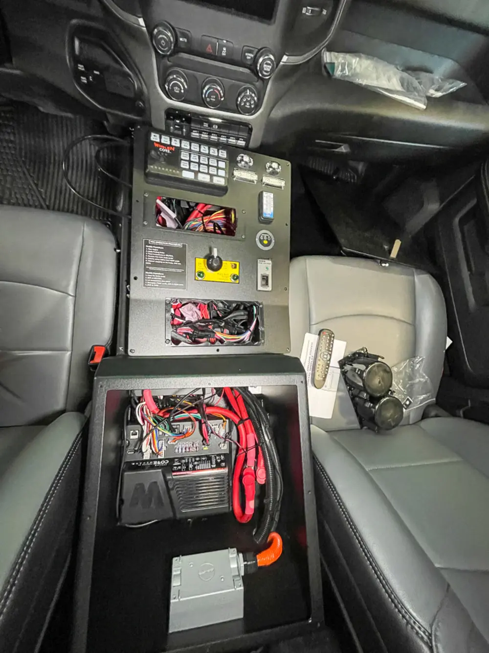 Exterior view of small fire truck showing cab, body compartments, and wheel/tire area.